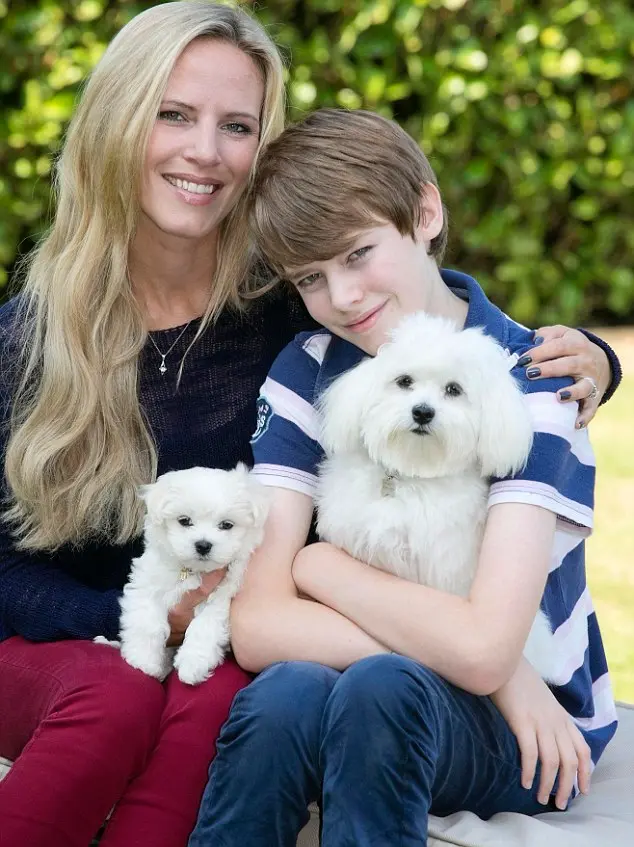 Lisa e seu filho Christian, com dois cães da raça Maltês. O filhote comprado anteriormente oriundo de fábrica de filhotes morreu em 6 dias. Foto: Daily Mail