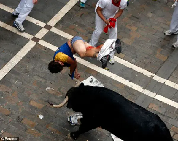Ameaçador: O corredor foi jogado ao ar pelo touro, chamado de “El Pilar”, após ser chifrado, na Rua Estafeta, durante a sexta corrida de touros. (Foto: Daily Mail)